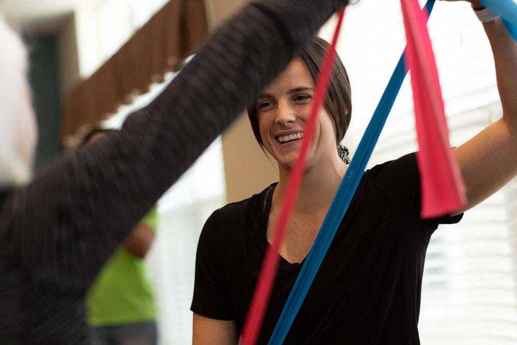 A fitness instructor leading a resistance-band class