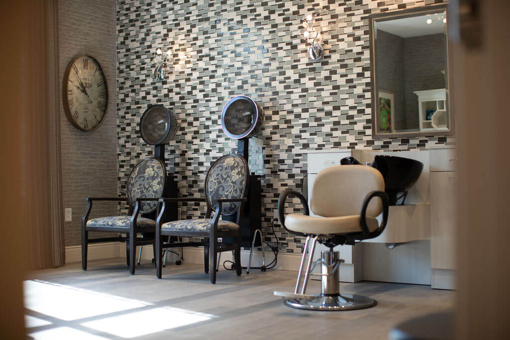 The community salon, with styling chairs and a wash station