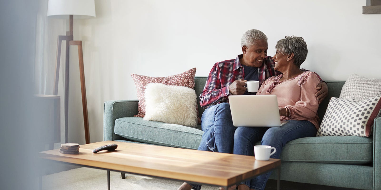 A Member and a visitor sharing coffee in a sunlit community lounge